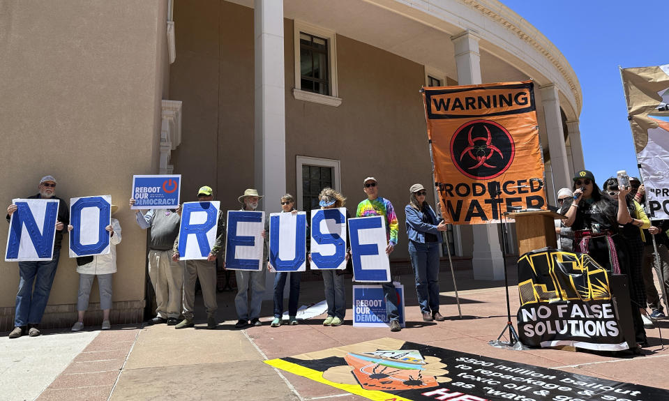 Protesters gather outside the New Mexico Statehouse to denounce a proposed rule for the treatment and recycling of oil-industry fracking water, Monday, May 6, 2024, in Santa Fe, N.M. Environmental officials in the nation's No. 2 state for petroleum production are taking initial steps toward regulating the treatment and reuse of oil-industry fracking water. New Mexico has been grappling with scarce water supplies, and fossil fuel producers are confronting shrinking opportunities for water disposal. The state's Water Quality Control Commission opened a weeklong series of hearings on Monday, May 13. (AP Photos/Morgan Lee)