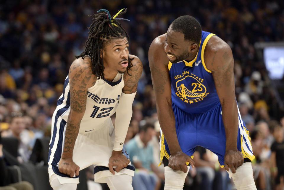 Memphis Grizzlies guard Ja Morant (12) and Golden State Warriors forward Draymond Green (23) talk during Game 1 of a second-round NBA basketball playoff series Sunday, May 1, 2022, in Memphis, Tenn. (AP Photo/Brandon Dill)