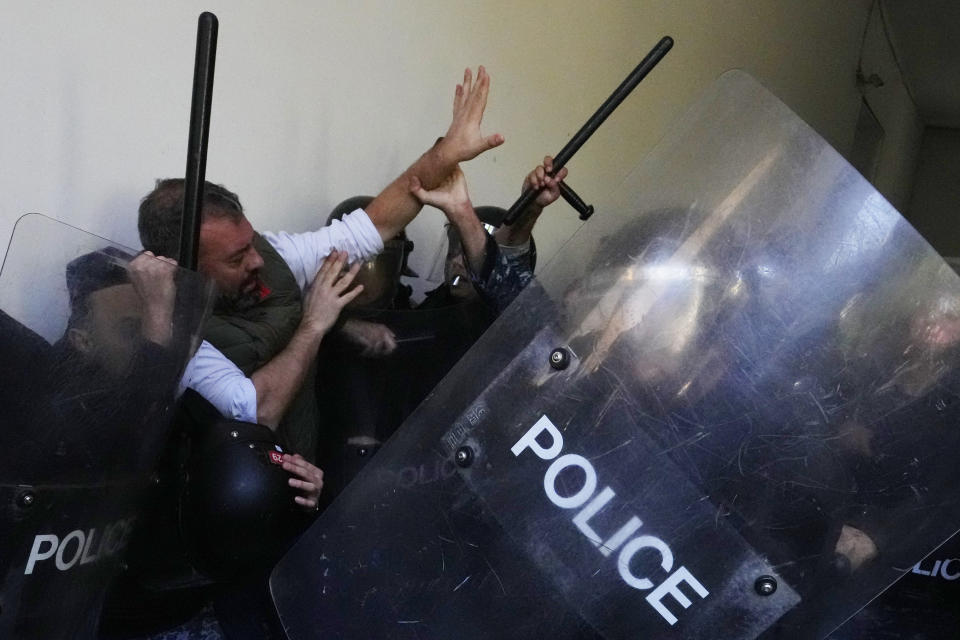 Anti-government protesters scuffle with riot police outside the ministry of Justice, in Beirut, Lebanon, Thursday, Jan. 26, 2023. Scores of protesters Thursday scuffled with riot police as they tried to break into the Beirut Justice Palace, rejecting an order from Lebanon's judiciary that further crippled the probe into a massive port explosion over two years ago. (AP Photo/Hassan Ammar)