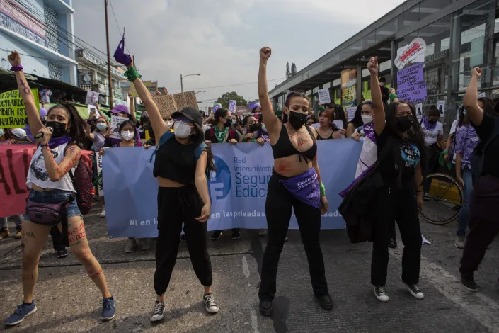 Women participate in a demonstration marking International Women's Day in downtown Guatemala City, Tuesday, March 8, 2022. (AP Photo/Oliver de Ros)