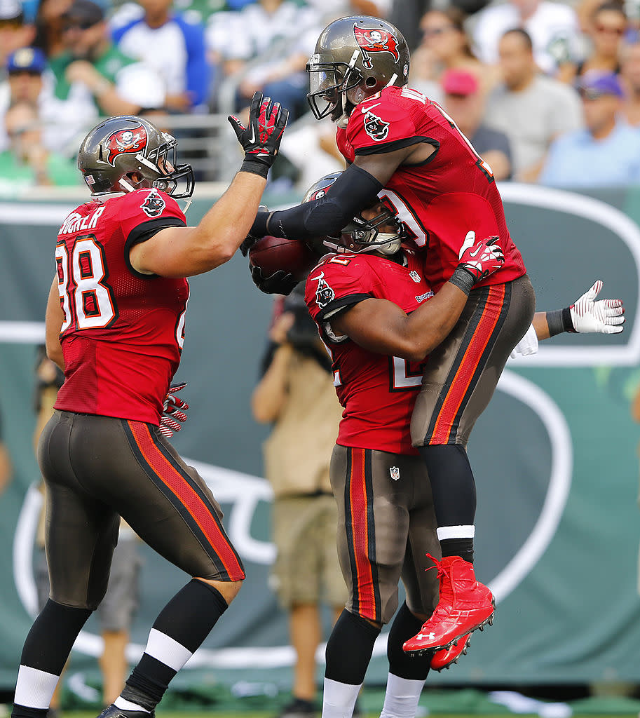 Wide receiver Mike Williams #19 celebrates his first quarter touchdown with teammate running back Doug Martin #22 and tight end Luke Stocker #88 against the New York Jets at MetLife Stadium on September 8, 2013 in East Rutherford, New Jersey. (Photo by Rich Schultz /Getty Images)