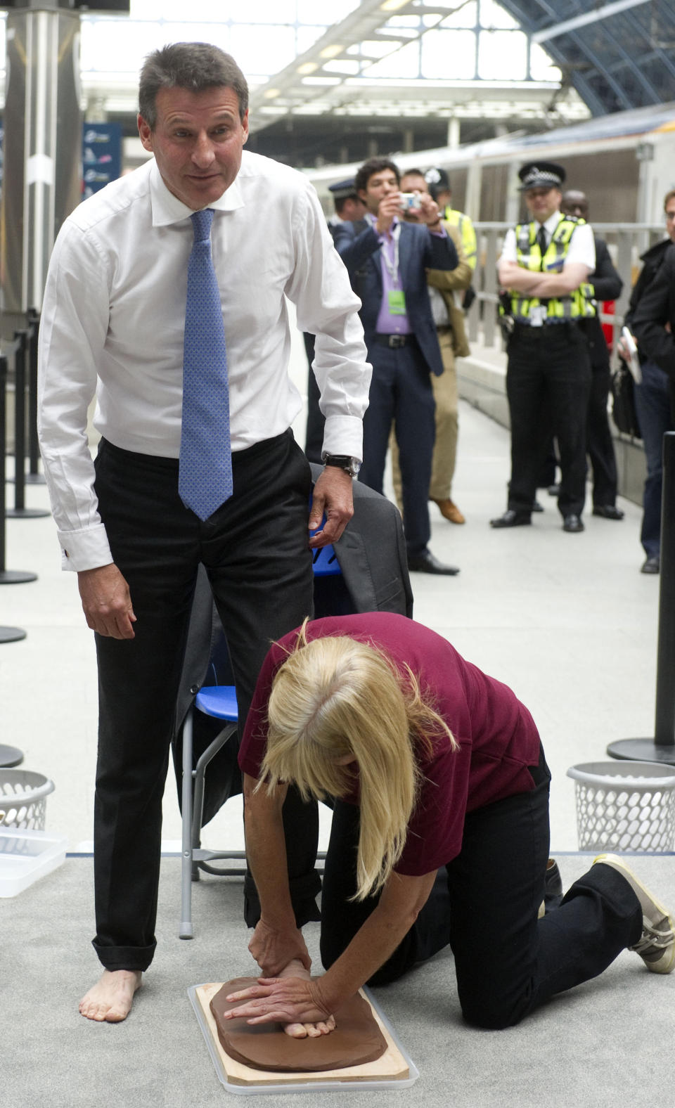 Lord Sebastian Coe, Chairman of the London 2012 Organising Committee, has his footprint cast in clay at St Pancras International Station in central London on July 27, 2011. The one-year countdown to the 2012 Olympics got under way on Wednesday as top officials predicted London was firmly on course to deliver a successful games with just 12 months to go. International Olympic Committee chief Jacques Rogge was set to extend a formal invitation to the world's athletes during a 7:00pm ceremony at Trafalgar Square in the culmination of day-long events to mark the one-year milestone. AFP PHOTO / CARL COURT (Photo credit should read CARL COURT/AFP/Getty Images)