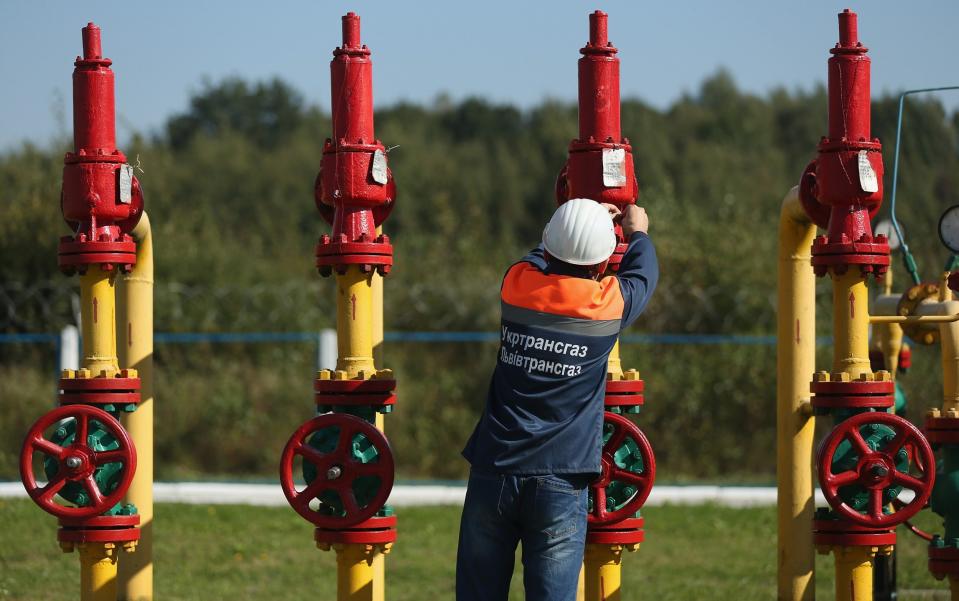 A worker checks metal label on a valve at the Dashava natural gas facility in Ukraine, a transit station along the natural gas pipelines linking to western Europe