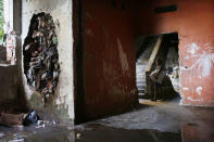 <p>A resident walks in one of the occupied buildings in the Mangueira favela, May 4, 2017, in Rio de Janeiro. (Photo: Mario Tama/Getty Images) </p>