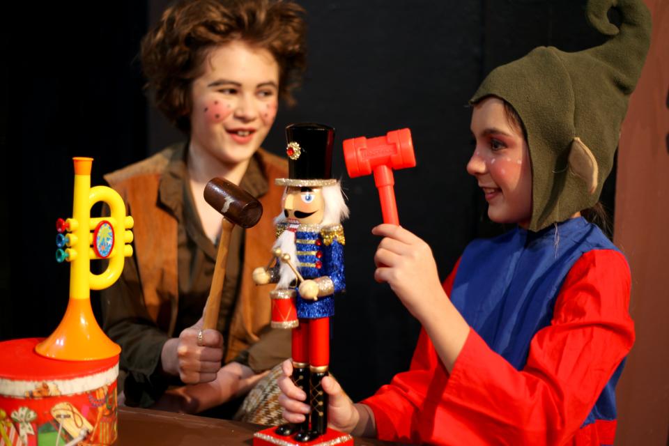 Simple Simon (Sici Clark) and a toymaker elf (Vivian Harris) work in the Master Toymaker's Workshop.