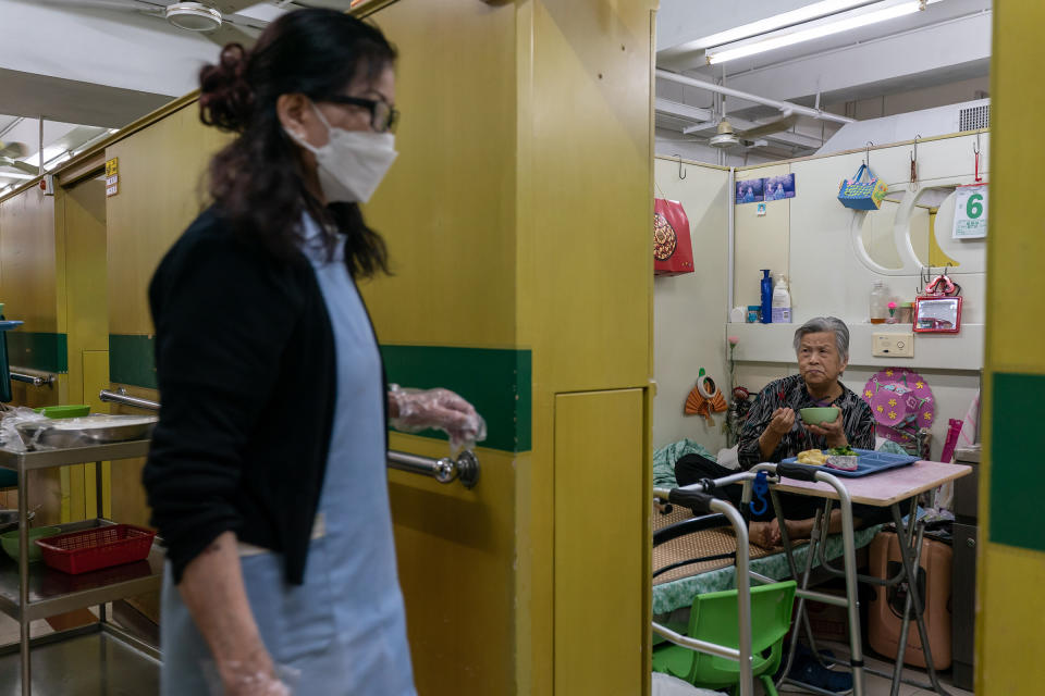 Yip Fung-cheung, 82, a resident of Hong Kong's Kei Tak (Tai Hang) Home for the Aged, eats dinner in her dormitory space.<span class="copyright">Anthony Kwan for TIME</span>
