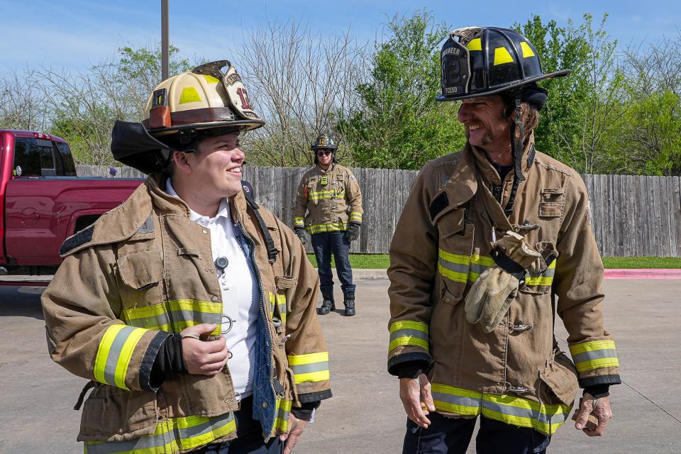 Ashley Brackett, talking to engineer Preston Muston during forcible entry training in Manor, is a rarity as a female battalion chief. "Being a battalion chief is a huge honor and milestone in this career that some people will never have the privilege of attaining," she said.