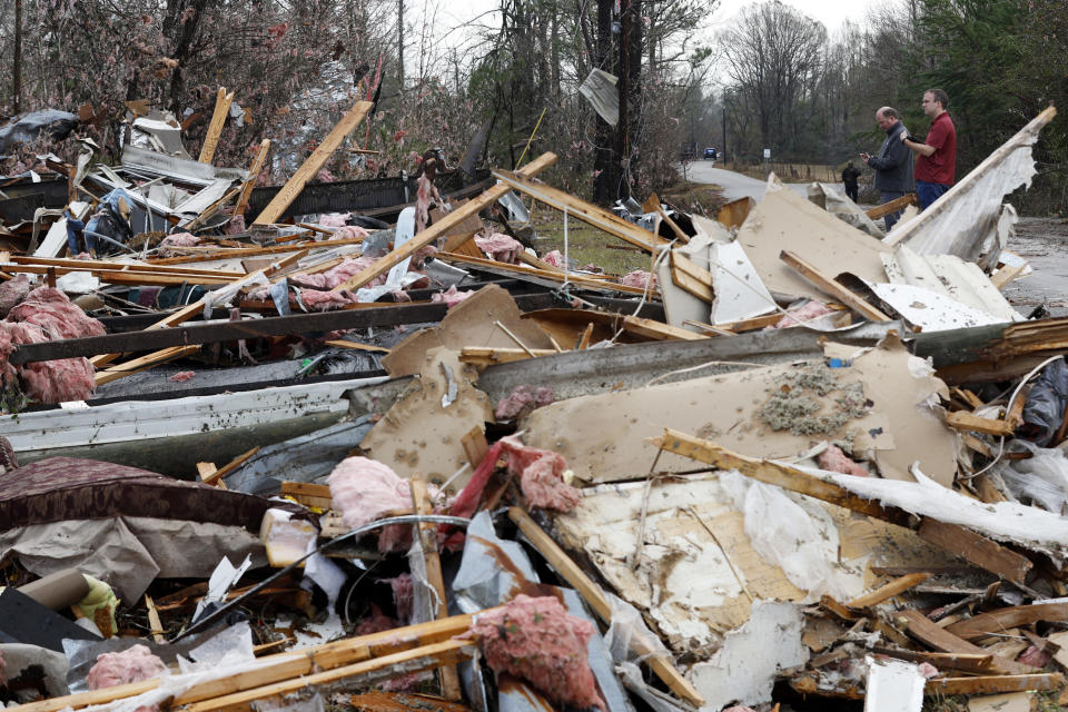 National Weather Service members survey damage, Wednesday, Nov. 30, 2022, in Flatwood, Ala., following a severe storm the day before. Two people were killed in the Flatwood community just north of the city of Montgomery. (AP Photo/Butch Dill)