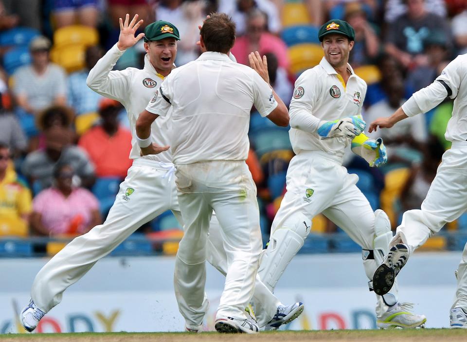 Australian cricketer Ryan Harris (C-back to camera) celebrates with teammates after dismissing West Indies batsman Adrian Barath during the first day of the first-of-three Test matches between Australia and West Indies at the Kensington Oval stadium in Bridgetown on April 7, 2012. West Indies won the toss and elected to bat first. AFP PHOTO/Jewel Samad (Photo credit should read JEWEL SAMAD/AFP/Getty Images)