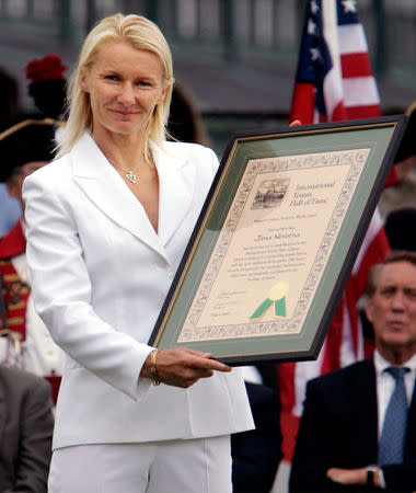 FILE PHOTO: Jana Novotna holds up her certificate after being inducted into the International Tennis Hall of Fame in Newport, Rhode Island July 9, 2005. During her twelve year career she won 24 singles titles and 76 doubles titles. REUTERS/Brian Snyder/File Photo