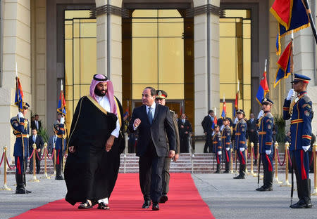 Saudi Crown Prince Mohammad Bin Salman listens to Egyptian President Abdel Fattah al-Sisi walking with Saudi Crown Prince Mohammad Bin Salman before his departure from Cairo Airport, Egypt, March 6, 2018, in this handout picture courtesy of the Egyptian Presidency. The Egyptian Presidency/Handout via REUTERS