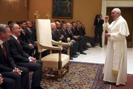 Pope Francis talks with the Bayern Munich soccer team during a private audience at the Palace of the Vatican in Vatican City, October 22, 2014. REUTERS/Alexander Hassenstein/Pool