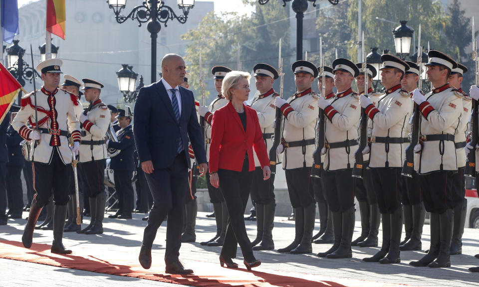 European Commission President Ursula von der Leyen, center, accompanied by North Macedonia's Prime Minister Dimitar Kovacevski, center left, walks past an honor guard squad, upon the arrival at the Government building in Skopje, North Macedonia, on Monday, Oct. 30, 2023. The President of the European Commission, Ursula von der Leyen started her four-day visit to the Western Balkans in North Macedonia, a tour that includes Kosovo, Montenegro, Serbia, and Bosnia and Herzegovina. (AP Photo/Boris Grdanoski)