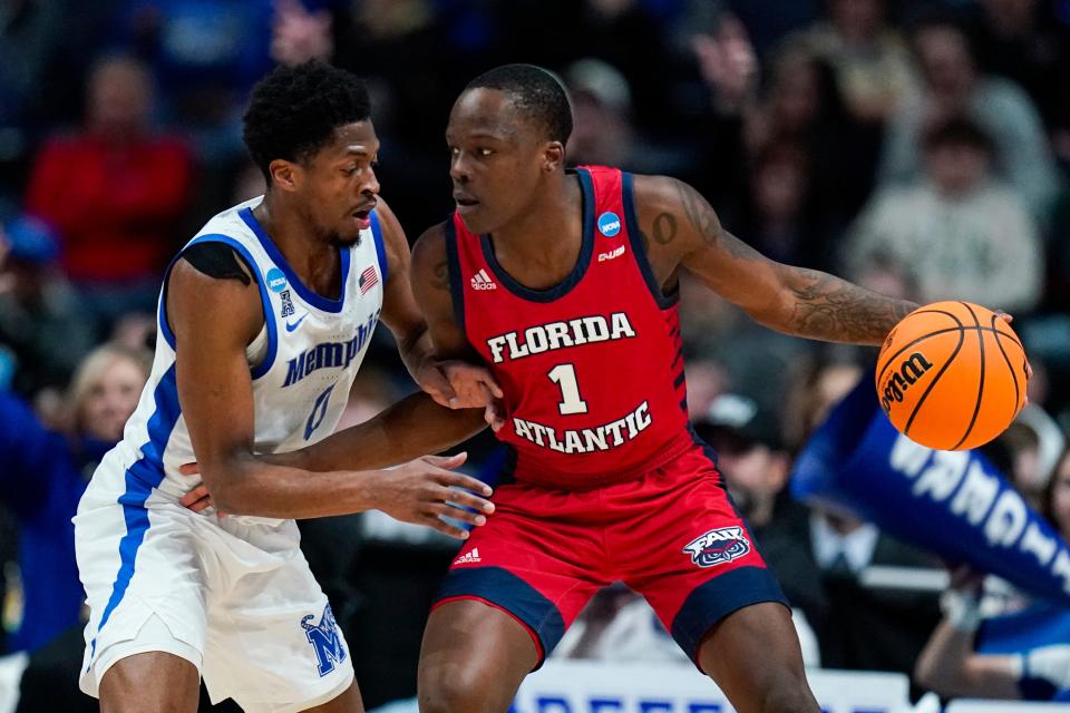 Florida Atlantic guard Johnell Davis (1) drives on Memphis guard Elijah McCadden (0) in the first half of a first-round college basketball game in the men's NCAA Tournament in Columbus, Ohio, Friday, March 17, 2023. (AP Photo/Michael Conroy)