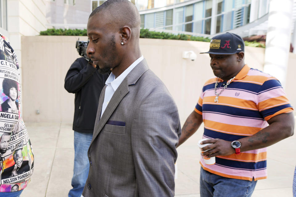 Michael Corey Jenkins, left, and Eddie Terrell Parker enter the Thad Cochran United States Courthouse in Jackson, Miss., Wednesday, March 20, 2024, for sentencing on the third of the six former Mississippi Rankin County law enforcement officers who committed numerous acts of racially motivated, violent torture on them in 2023. The six former law officers pleaded guilty to a number of federal charges for torturing them and their sentencing began Tuesday in federal court. (AP Photo/Rogelio V. Solis)