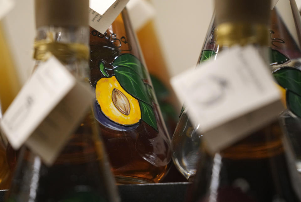 Bottles of brandy in a bar in Belgrade, Serbia, Friday, Nov. 11, 2022. The U.N.'s culture and education organization is set later this month to review Serbia's bid to include "social practices and knowledge related to the preparation and use of the traditional plum spirit - sljivovica" on the list of world intangible cultural heritage. (AP Photo/Darko Vojinovic)