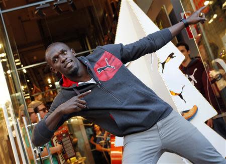 Jamaica's double Olympic champion sprinter Usain Bolt strikes a pose while inaugurating a Puma store in Barcelona, in this November 23, 2012 file photograph. REUTERS/Albert Gea/Files