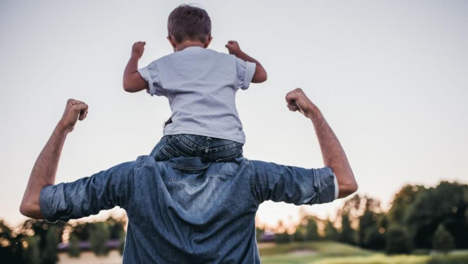 Dad and son having fun outdoor. Healthy living concept