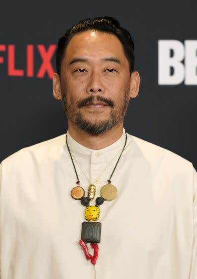 David Choe in an abstract necklace and white tunic at the Beef premiere
