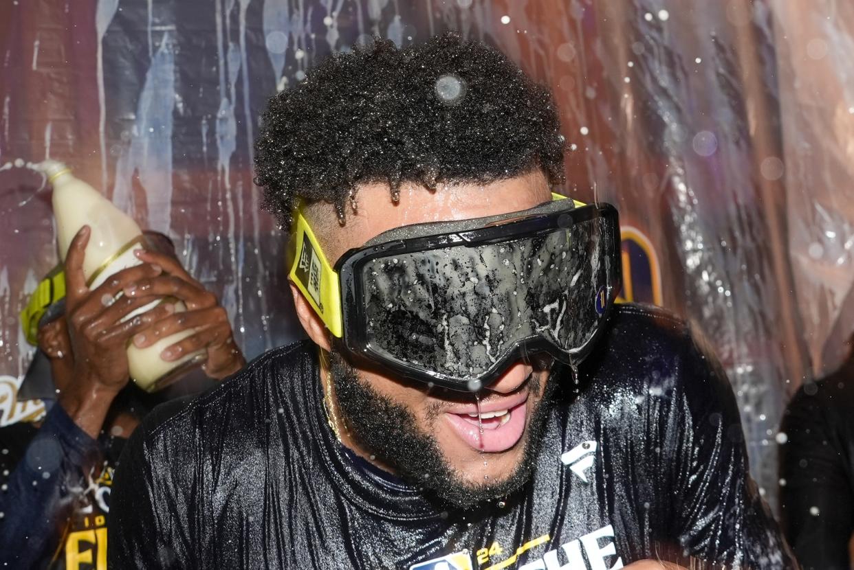 Milwaukee Brewers' Jackson Chourio is douced after a baseball game against the Philadelphia Phillies Wednesday, Sept. 18, 2024, in Milwaukee. The Brewers won 2-1 and clinched the National League Central division. (AP Photo/Morry Gash)