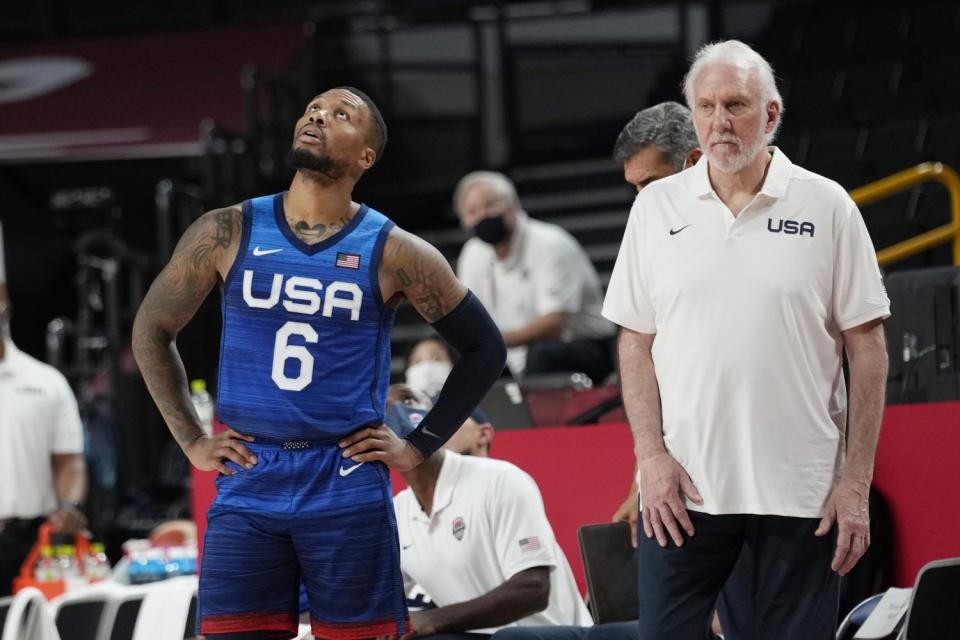 Damian Lillard and Gregg Popovich wait for a replay