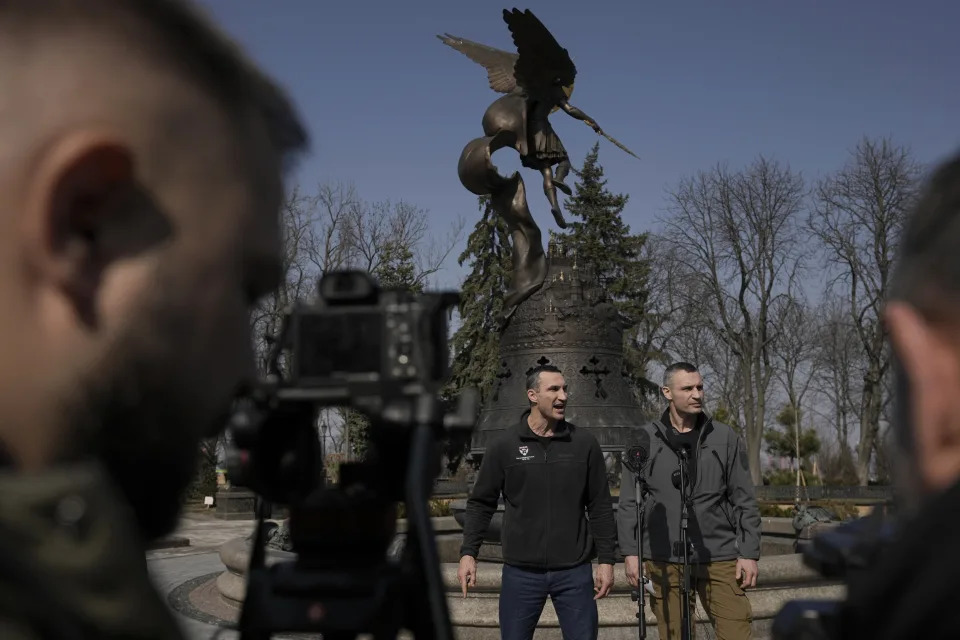 Kyiv Mayor Vitali Klitschko, right, stands next to his brother, former heavyweight boxing world champion Wladimir Klitschko, during a press conference, in Kyiv, Ukraine,Wednesday, March 23, 2022. From a public park in the city, Mayor Klitschko, said 264 civilians had so far died from Russian bombardment on the capital, including four children. As he spoke to reporters, explosions and loud gunfire echoed across the city. (AP Photo/Vadim Ghirda)