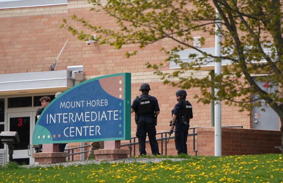 Law enforcement officers stand outside the Mount Horeb Intermediate Center in Mount Horeb, Wisconsin on Wednesday, May 1, 2024.