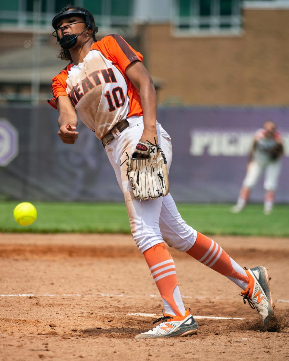 Heath's Renae Cunningham (10) fires in a pitch against John Glenn during the Division II regional finals Saturday at Pickerington Central. Cunningham struck out 11 in five innings during the Bulldogs' 12-5 victory.