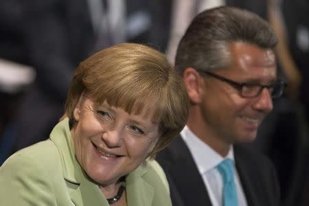 German Chancellor Angela Merkel (L) and the President of the Federation of German Industry (BDI) Ulrich Grillo attend the BDI's Day of the German Industry conference in Berlin, June 11, 2013. REUTERS/Thomas Peter