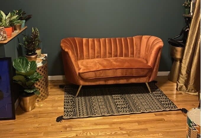 Reviewer's picture of the loveseat, which has a back that wraps around the sides and slightly into the front, in almost a "C" shape