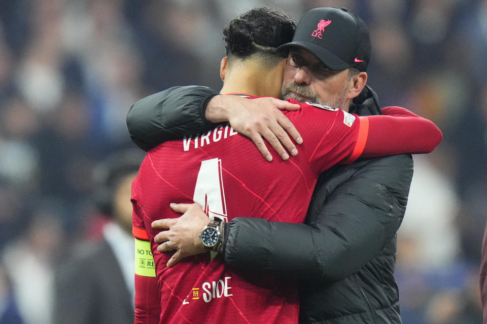 Liverpool's manager Jurgen Klopp embraces Liverpool's Virgil van Dijk after the Champions League final soccer match between Liverpool and Real Madrid at the Stade de France in Saint Denis near Paris, Saturday, May 28, 2022. Real won 1-0. (AP Photo/Petr David Josek)