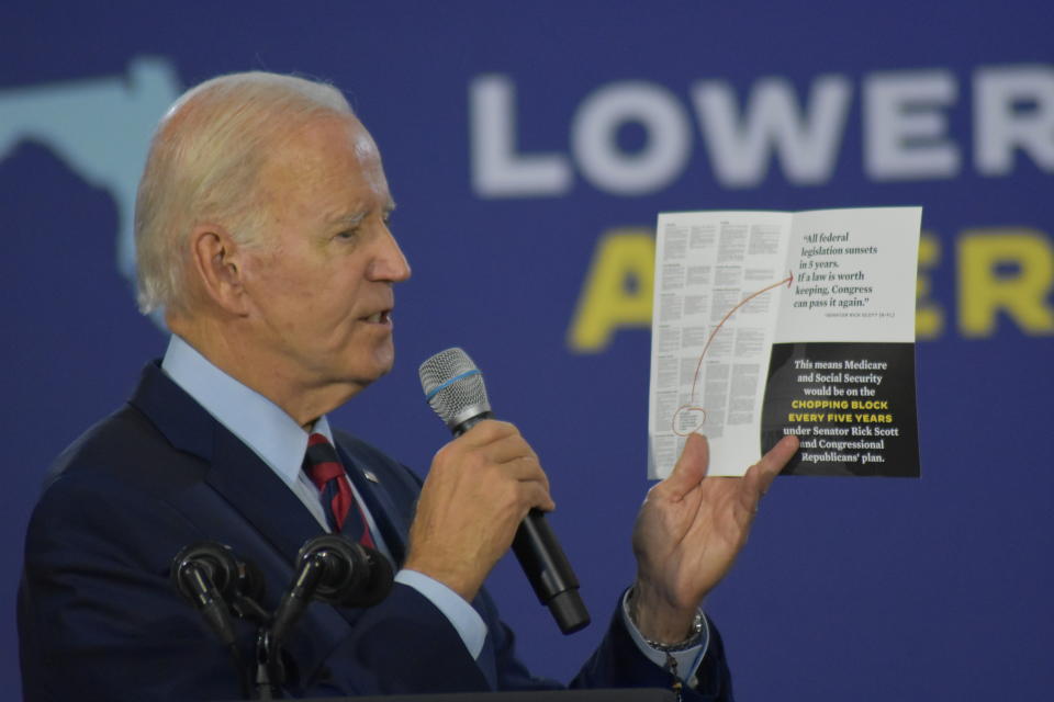 HALLANDALE BEACH, UNITED STATES - NOVEMBER 1: U.S. President Joe Biden holds up a pamphlet as he delivers remarks on protecting Social Security and Medicare and lowering prescription drug costs in Hallandale Beach, Florida, United States on November 1, 2022. (Photo by Kyle Mazza/Anadolu Agency via Getty Images)