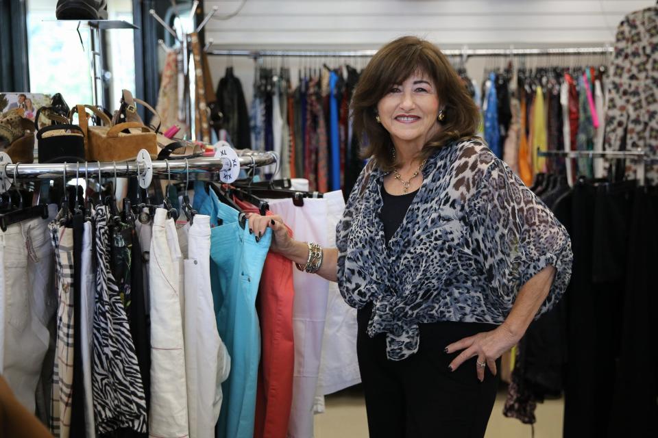 Owner Sandra DeCola poses for a portrait at DC Natick Consignments in Natick, Aug. 15, 2022. DeCola worked part time at the store for 10 years before deciding to buy it.