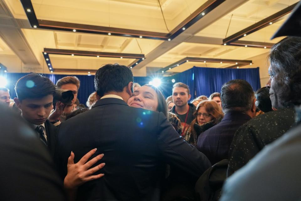 GOP presidential candidate Vivek Ramaswamy hugs supporter Lily Duncan after ending his presidential bid on Monday, Jan. 15, 2024, at Surety Hotel in Des Moines.