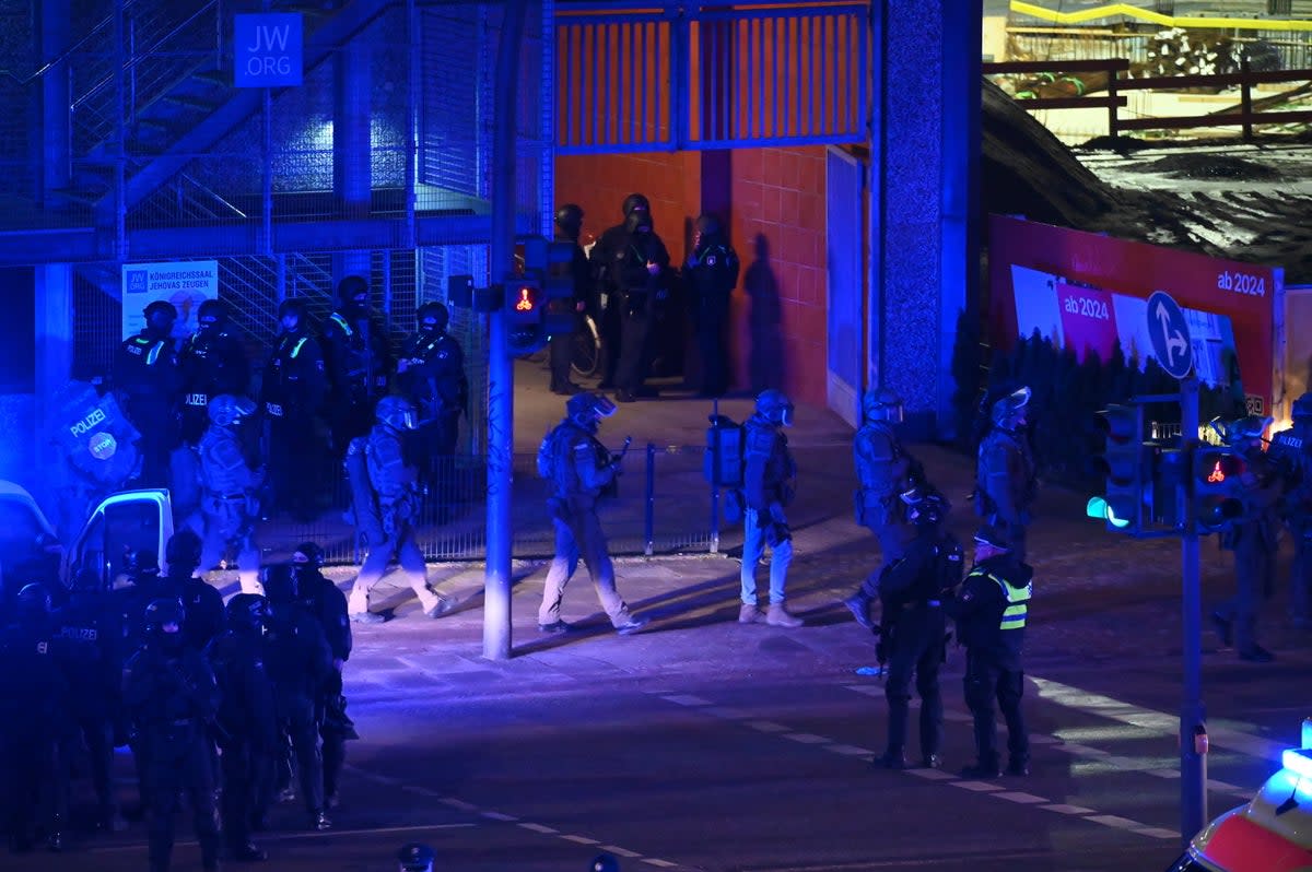 Armed police officers near the scene of a shooting in Hamburg, Germany (AP)