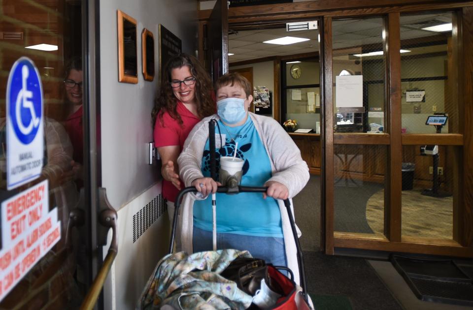 Clinton Transit "blue bus" transit driver Molly Berger, left, helps guide Andrea Ordiway to the bus following one of Ordiway's volunteer shifts where she works with senior citizens on Wednesday, June 14, 2023, in St. Johns. Ordiway will be dropped off at St. Vincent de Paul in St. Johns to drop off donations before taking the bus back to her home in Ovid.