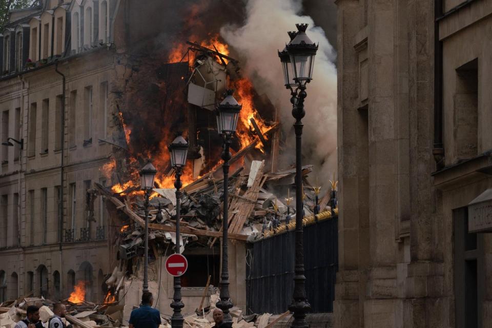 Smoke billows from rubbles of a building at Place Alphonse-Laveran (AFP via Getty Images)