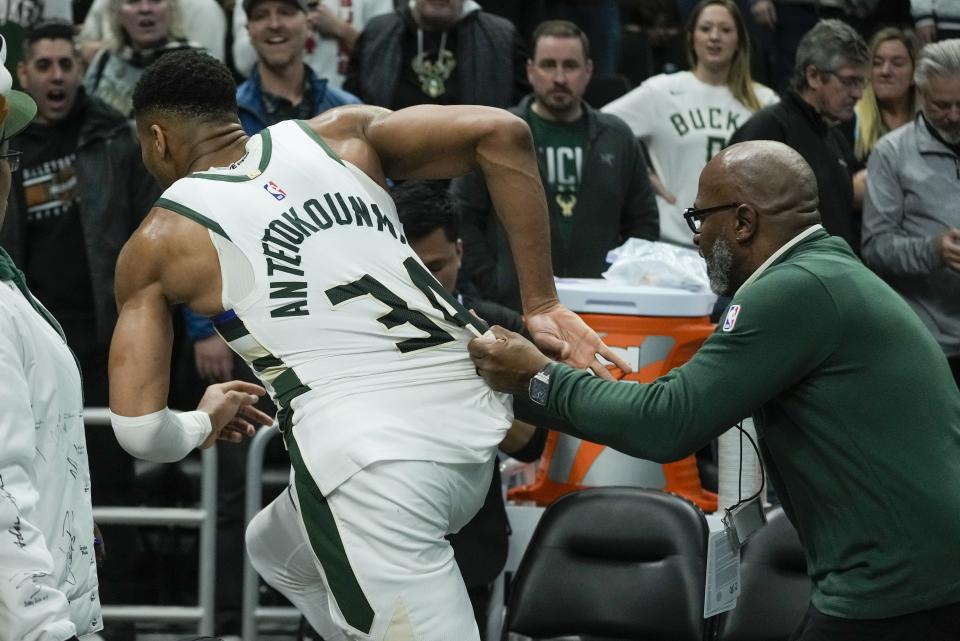 Milwaukee Bucks' Giannis Antetokounmpo runs toward the Indiana Pacers locker room after an NBA basketball game Wednesday, Dec. 13, 2023, in Milwaukee. (AP Photo/Morry Gash)