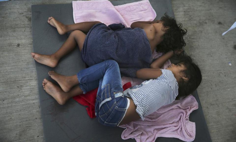 Migrant children sleep on a mattress on the floor of the AMAR migrant shelter in Nuevo Laredo, Mexico, in July 2019.