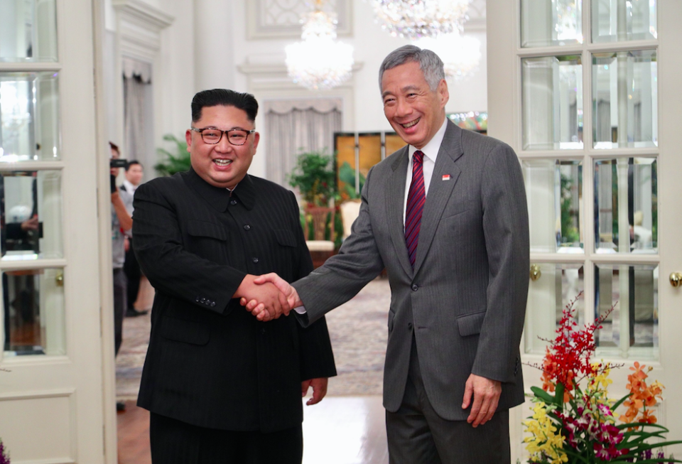 Kim Jong-un with Singapore prime minister Lee Hsien Loong (Picture: Rex)