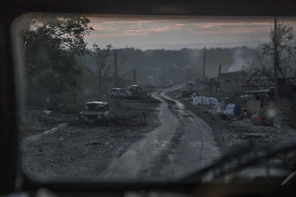 The gutted remains of cars lie along a road during heavy fighting at the front line in Severodonetsk, Luhansk region, Ukraine, Wednesday, June 8, 2022. (AP Photo/Oleksandr Ratushniak)