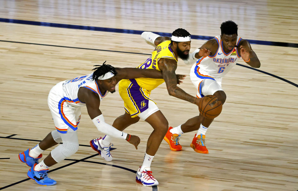 Los Angeles Lakers' Markieff Morris, center, battles for the ball with Oklahoma City Thunder's Luguentz Dort (5) and Hamidou Diallo (6) during the first half of an NBA basketball game Wednesday, Aug. 5, 2020, in Lake Buena Vista, Fla. (Kevin C. Cox/Pool Photo via AP)