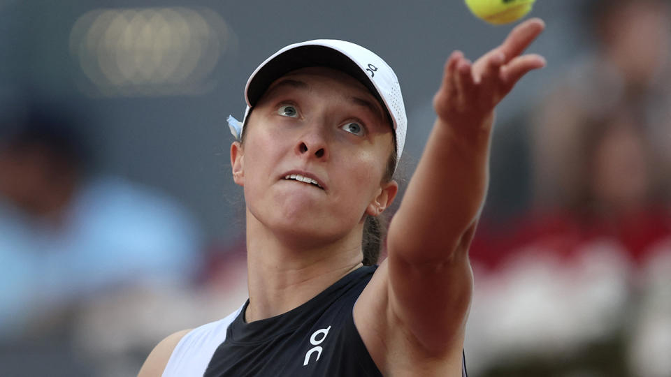 Iga Swiatek serves the ball at the Madrid Open.