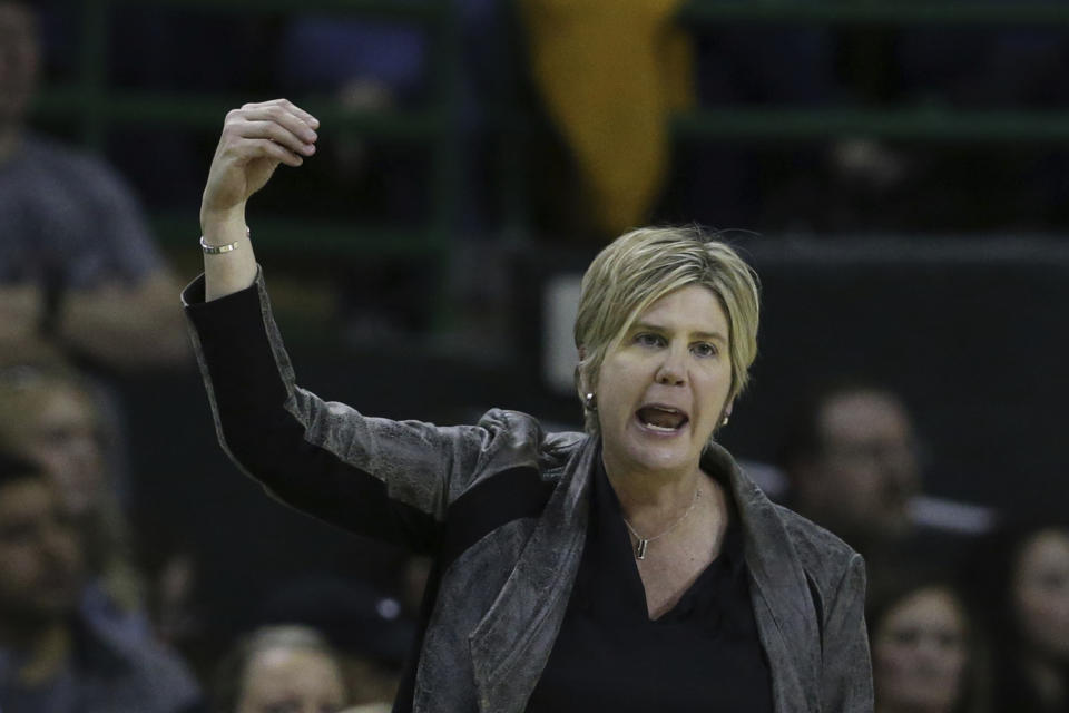 Marlene Stollings yells on a basketball court.