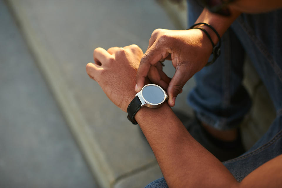 A user interacts with a smartwatch.