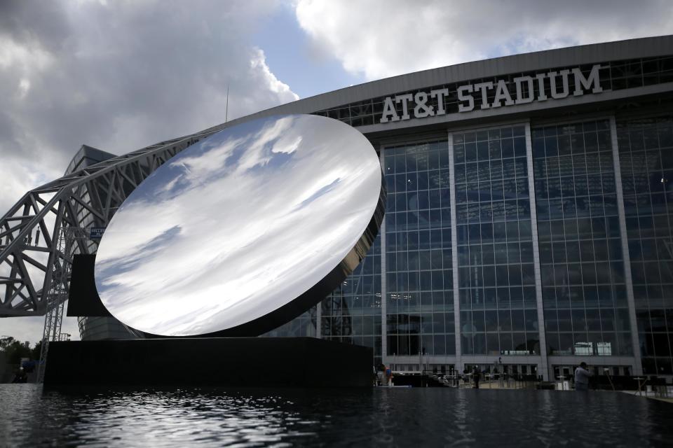 Clouds are reflected on Anish Kapoor's "Sky Mirror", an art piece that sits placed over a reflecting pool on the east plaza of AT&T Stadium, home of the Dallas Cowboys , Friday, Oct. 11, 2013, in Arlington, Texas. The concave disc covered in polished steel had temporary homes in New York, London and Sydney before getting a permanent spot in a black granite fountain outside the huge sliding glass doors on the east side of the stadium. (AP Photo/Tony Gutierrez)