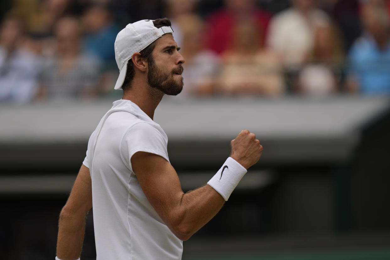 Russia's Karen Khachanov celebrates after winning the third set against Canada's Denis Shapovalov during the men's singles quarterfinals match on day nine of the Wimbledon Tennis Championships in London, Wednesday, July 7, 2021. (AP Photo/Alastair Grant)