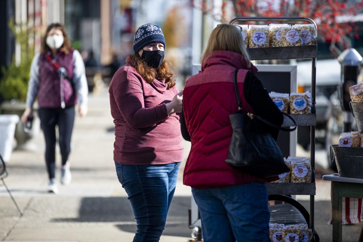 Melanie Fishcer of Froggy's Popcorn talks to a customer during the Small Business Saturday event in NuLu.  Nov. 28, 2020.