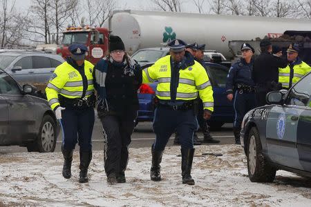 Police detain a protester who was part of a group who blocked Interstate 93 southbound during the morning rush hour in Somerville, Massachusetts January 15, 2015. REUTERS/Brian Snyder