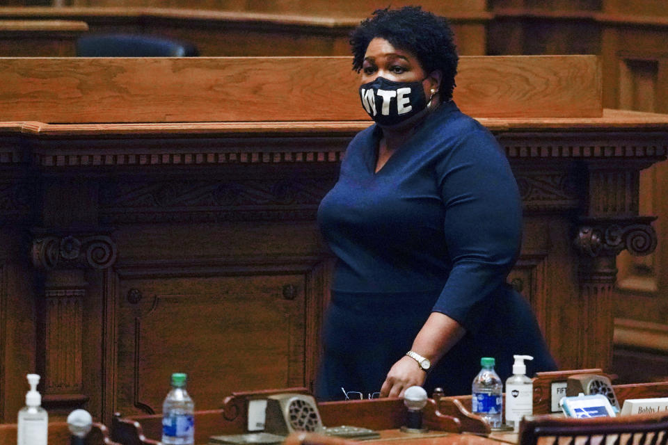 FILE - In this Dec. 14, 2020, file photo, Democrat Stacey Abrams walks on Senate floor before of members of Georgia's Electoral College cast their votes at the state Capitol in Atlanta. In Georgia, voting rights activist Abrams is expected to make a second run for governor in 2022. (AP Photo/John Bazemore, Pool, File)